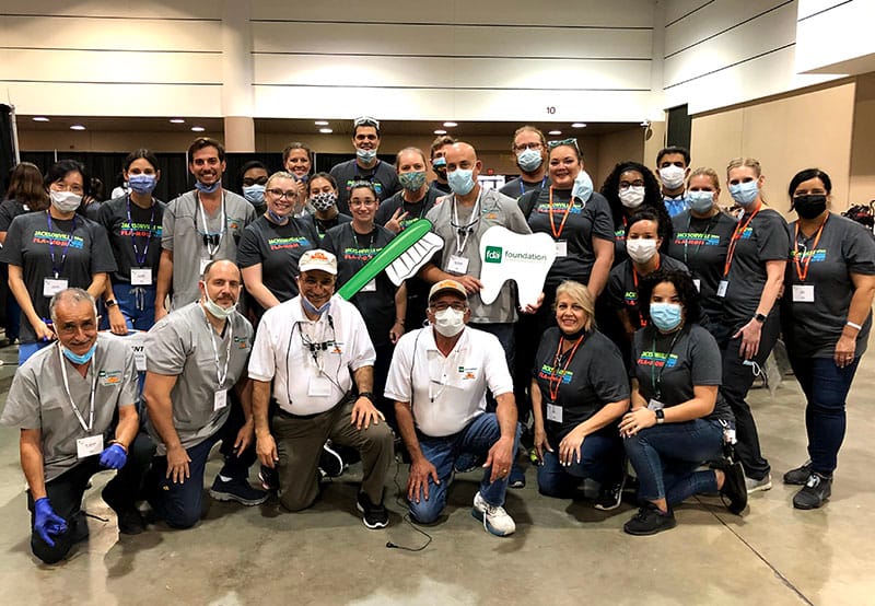 Dentists at a charity event where they help fix teeth for economically disadvantaged persons. Full group photo of all dentists